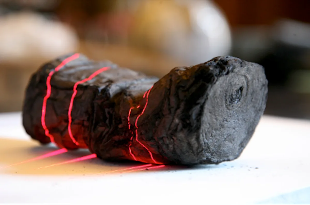A carbonised, still-sealed ancient scroll shown beside the same X-ray CT volume virtually unrolled into a flat surface